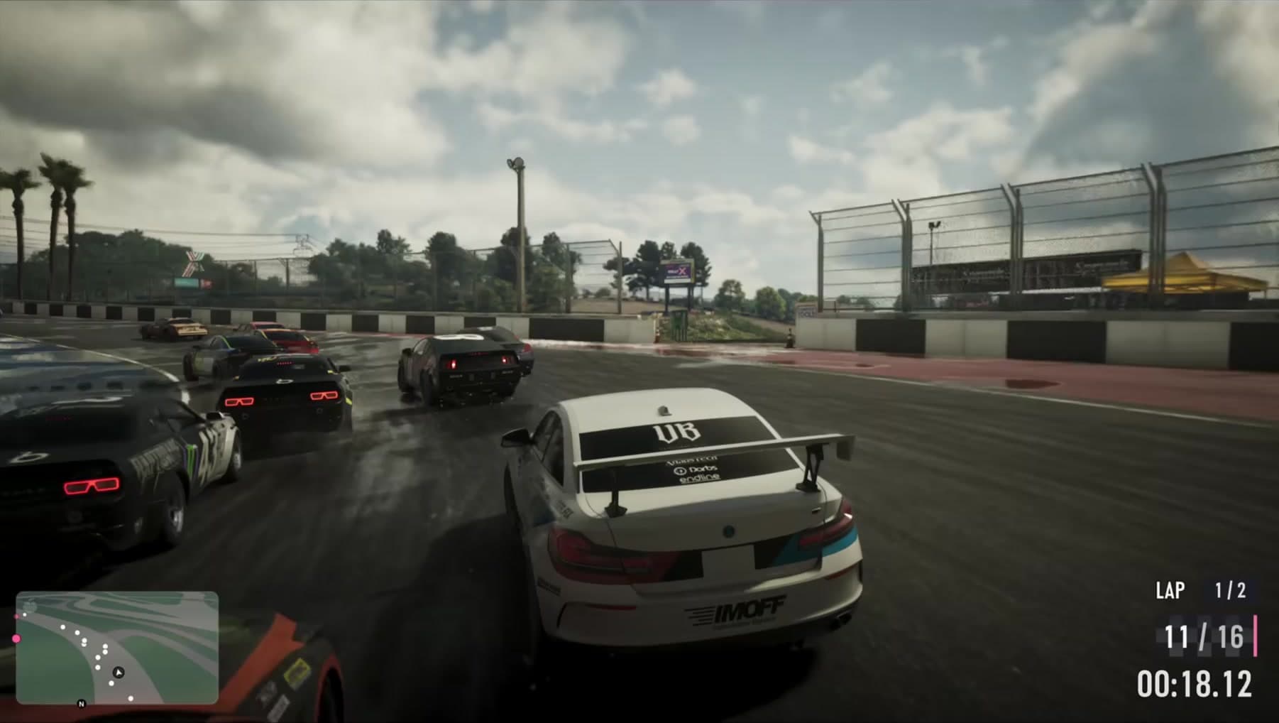 An Ubermacht race car slides through the pack with the lap and position HUD live