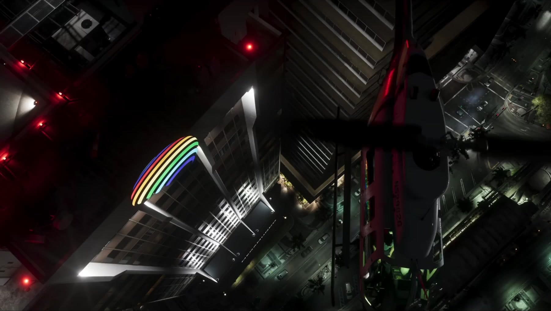 A helicopter over the rainbow crowned deco tower at night